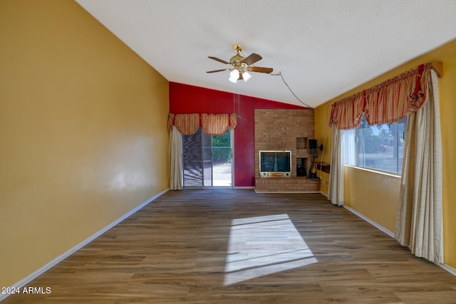 322 N Flynn Jans Ct, Pearce, AZ 85625 - unfurnished living room with lofted ceiling, ceiling fan, healthy amount of natural light, baseboards, and a fireplace