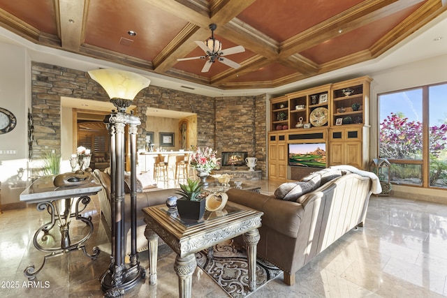 13249 E Summit Dr, Scottsdale, AZ 85259 - living room featuring a ceiling fan, a fireplace, beamed ceiling, coffered ceiling, and ornamental molding