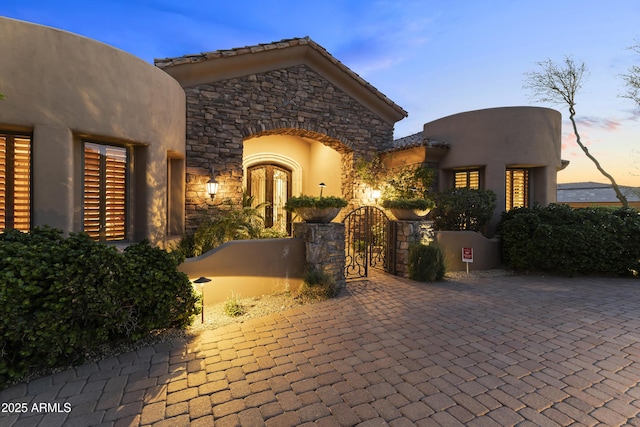 13249 E Summit Dr, Scottsdale, AZ 85259 - doorway to property with stone siding, a gate, and driveway