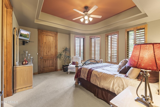 13249 E Summit Dr, Scottsdale, AZ 85259 - carpeted bedroom featuring a tray ceiling, baseboards, and ceiling fan