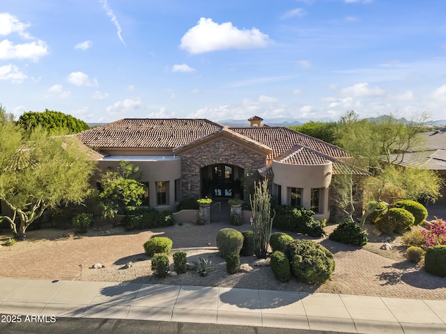 13249 E Summit Dr, Scottsdale, AZ 85259 - mediterranean / spanish house featuring stone siding, a tile roof, and stucco siding