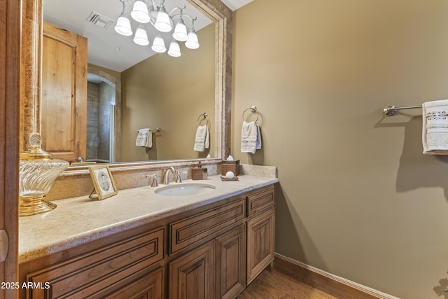 13249 E Summit Dr, Scottsdale, AZ 85259 - bathroom featuring vanity, wood finished floors, and baseboards