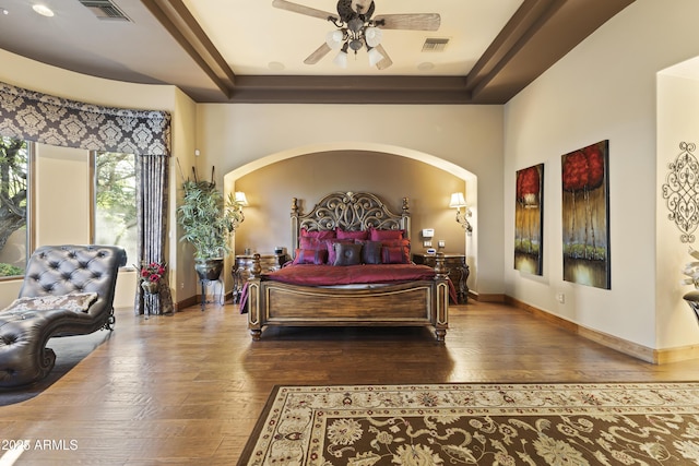 13249 E Summit Dr, Scottsdale, AZ 85259 - bedroom with hardwood / wood-style flooring, arched walkways, baseboards, and a raised ceiling