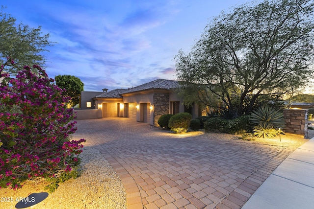 13249 E Summit Dr, Scottsdale, AZ 85259 - view of front of property featuring a garage, decorative driveway, stucco siding, and stone siding