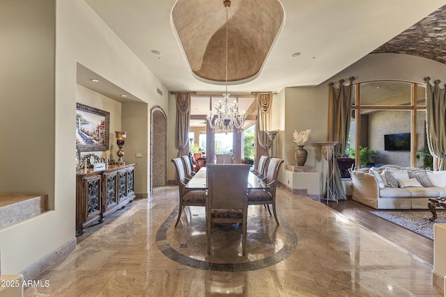 13249 E Summit Dr, Scottsdale, AZ 85259 - dining room with a chandelier, baseboards, marble tiled flooring, and arched walkways