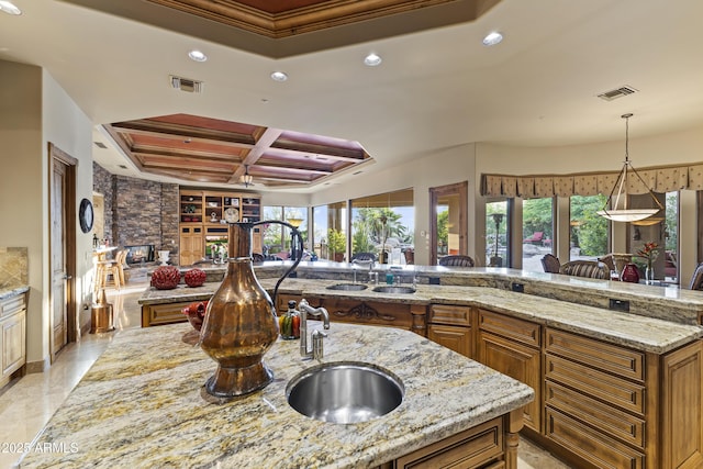 13249 E Summit Dr, Scottsdale, AZ 85259 - kitchen with coffered ceiling, recessed lighting, brown cabinets, light stone counters, and ornamental molding