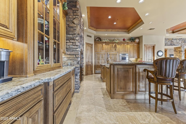 13249 E Summit Dr, Scottsdale, AZ 85259 - bar area featuring stainless steel oven, a tray ceiling, stone tile floors, crown molding, and recessed lighting