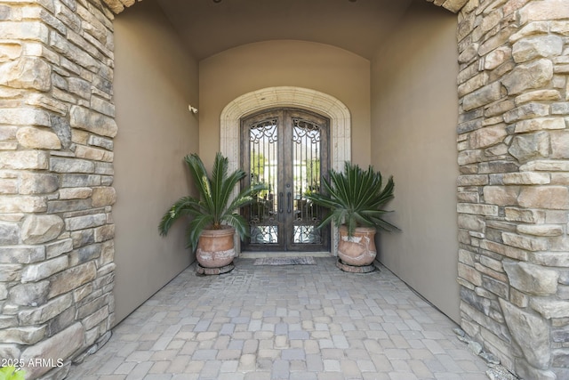 13249 E Summit Dr, Scottsdale, AZ 85259 - doorway to property featuring french doors, stone siding, and stucco siding