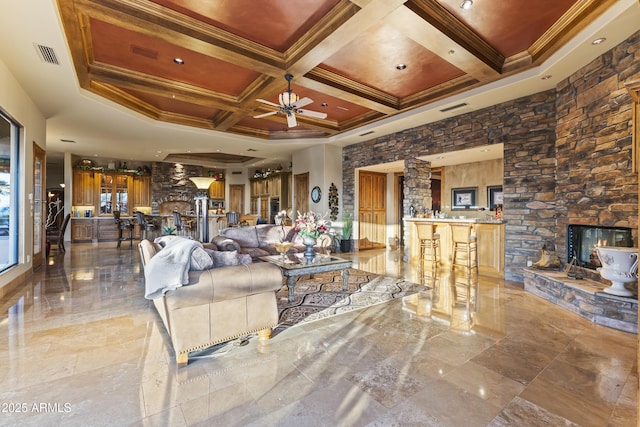 13249 E Summit Dr, Scottsdale, AZ 85259 - living area featuring coffered ceiling, a ceiling fan, crown molding, beamed ceiling, and a fireplace