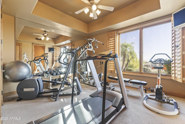 13249 E Summit Dr, Scottsdale, AZ 85259 - workout area featuring a tray ceiling, ceiling fan, plenty of natural light, and baseboards