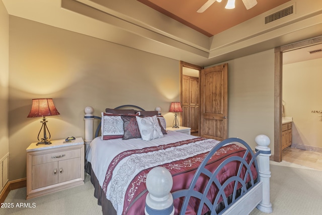 13249 E Summit Dr, Scottsdale, AZ 85259 - bedroom with light carpet, baseboards, ensuite bathroom, and a ceiling fan