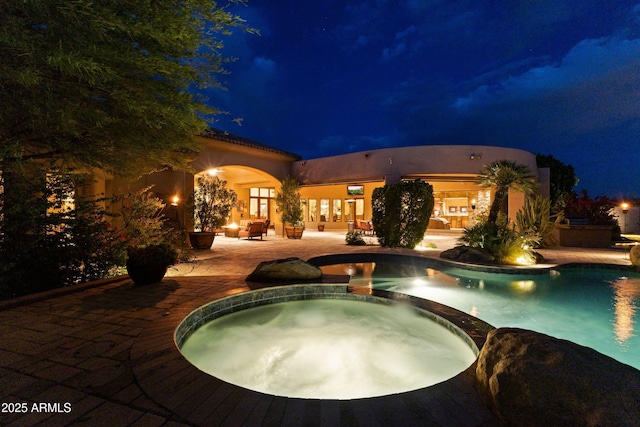 13249 E Summit Dr, Scottsdale, AZ 85259 - pool at twilight featuring a patio area and a pool with connected hot tub