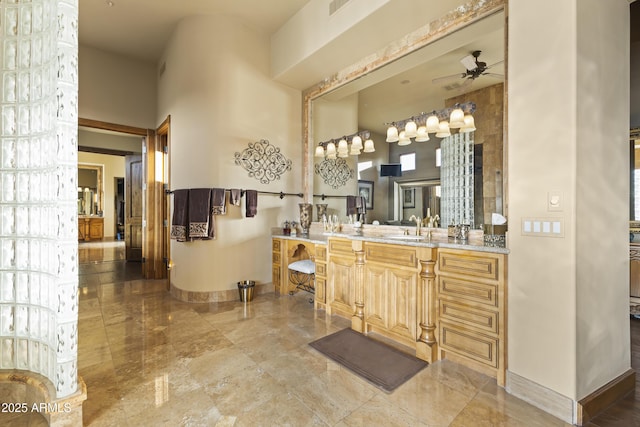 13249 E Summit Dr, Scottsdale, AZ 85259 - bathroom with a ceiling fan, baseboards, vanity, and marble finish floors