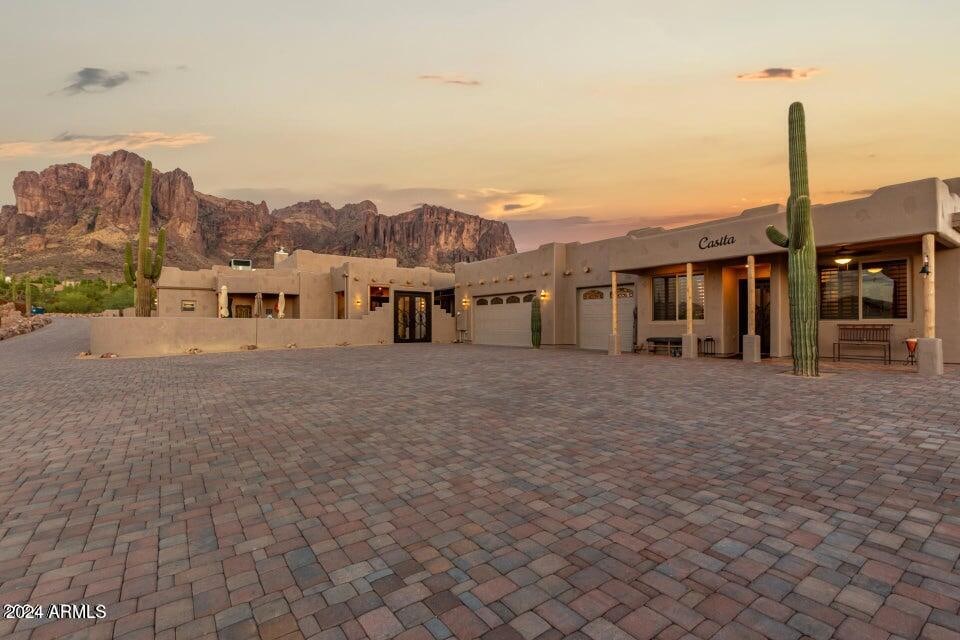 adobe home featuring a mountain view and a garage