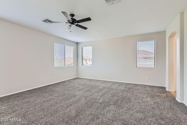8766 W Hayward Ave, Glendale, AZ 85305 - carpeted empty room featuring ceiling fan, baseboards, and arched walkways