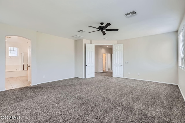 8766 W Hayward Ave, Glendale, AZ 85305 - carpeted spare room with a ceiling fan, arched walkways, and baseboards