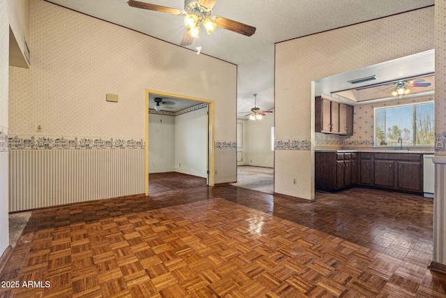 6015 W Acoma Dr, Glendale, AZ 85306 - spare room featuring wallpapered walls and a ceiling fan