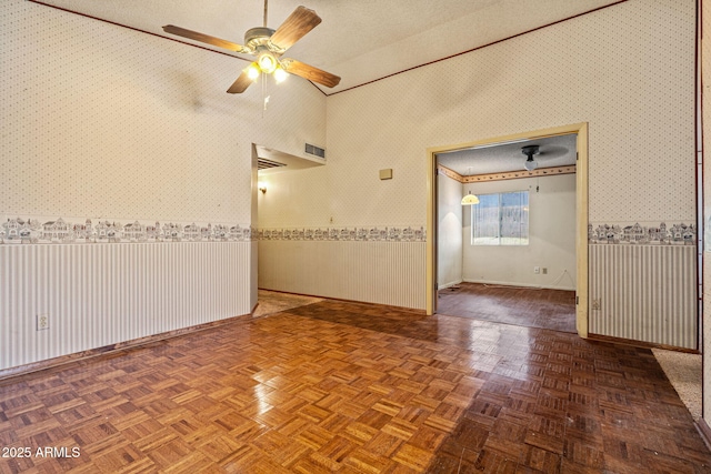 6015 W Acoma Dr, Glendale, AZ 85306 - unfurnished room featuring wallpapered walls, ceiling fan, and vaulted ceiling