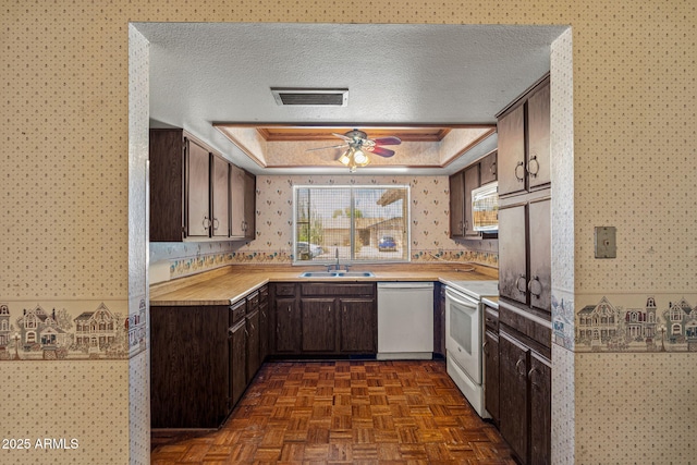 6015 W Acoma Dr, Glendale, AZ 85306 - kitchen with wallpapered walls, white appliances, light countertops, dark brown cabinets, and a ceiling fan