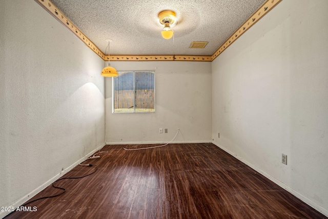 6015 W Acoma Dr, Glendale, AZ 85306 - spare room with a textured ceiling and wood finished floors