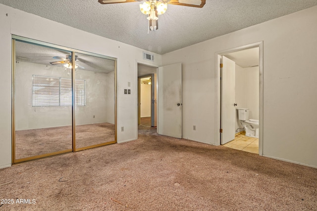 6015 W Acoma Dr, Glendale, AZ 85306 - unfurnished bedroom with carpet flooring, a textured ceiling, a closet, connected bathroom, and a ceiling fan