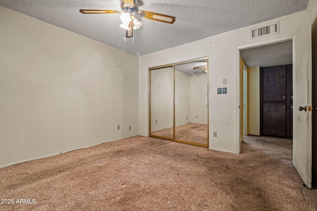 6015 W Acoma Dr, Glendale, AZ 85306 - unfurnished bedroom featuring carpet, a textured ceiling, a closet, and a ceiling fan