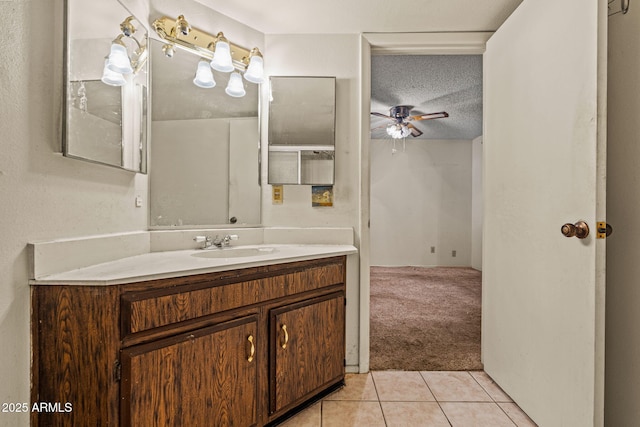 6015 W Acoma Dr, Glendale, AZ 85306 - bathroom featuring vanity, a ceiling fan, tile patterned flooring, and a textured ceiling