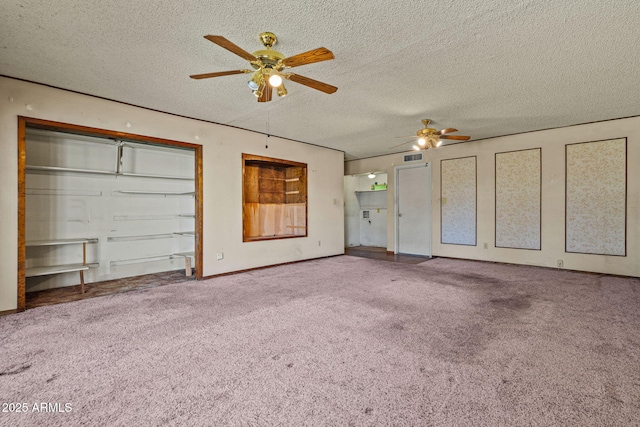6015 W Acoma Dr, Glendale, AZ 85306 - unfurnished living room featuring a ceiling fan, carpet floors, and a textured ceiling