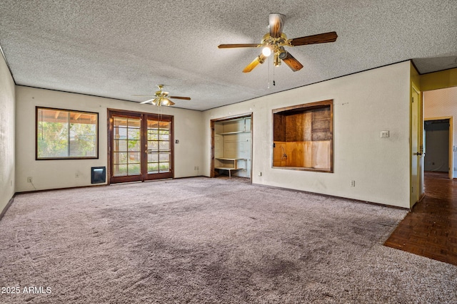 6015 W Acoma Dr, Glendale, AZ 85306 - unfurnished living room with carpet floors, a ceiling fan, a textured ceiling, and french doors