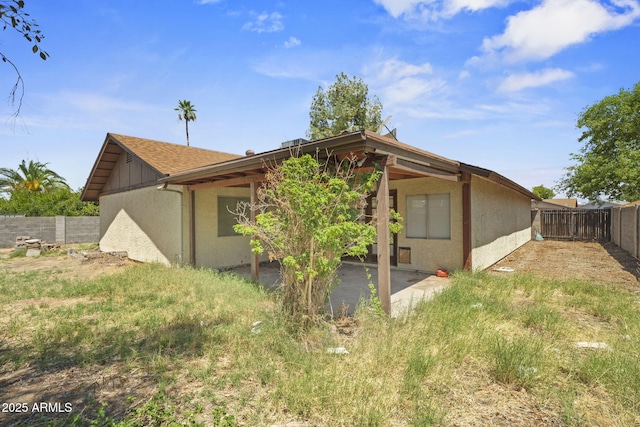 6015 W Acoma Dr, Glendale, AZ 85306 - rear view of property featuring a fenced backyard, stucco siding, and a patio area