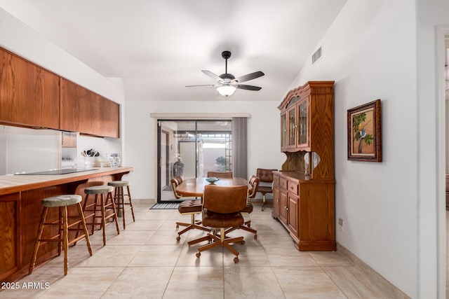 tiled dining area featuring ceiling fan