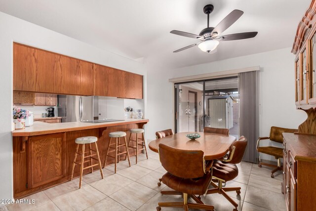 dining room with light tile patterned flooring and ceiling fan