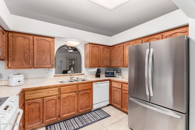 kitchen with white appliances, ceiling fan, light tile patterned floors, and sink