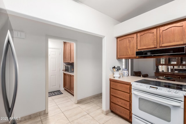 kitchen featuring white electric range and light tile patterned floors