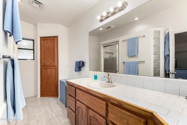 bathroom featuring tile patterned flooring and vanity