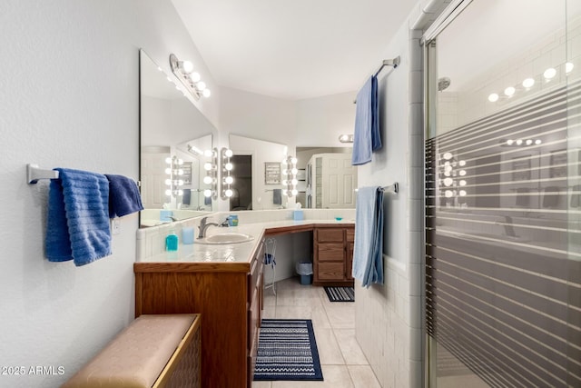 bathroom featuring vanity, tile patterned floors, and a shower with shower door