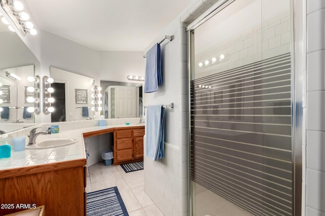 bathroom with an enclosed shower, tile patterned flooring, and vanity