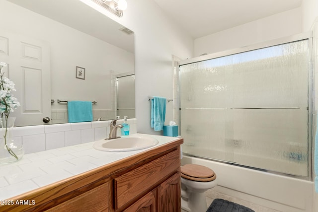 full bathroom featuring toilet, enclosed tub / shower combo, tasteful backsplash, and vanity