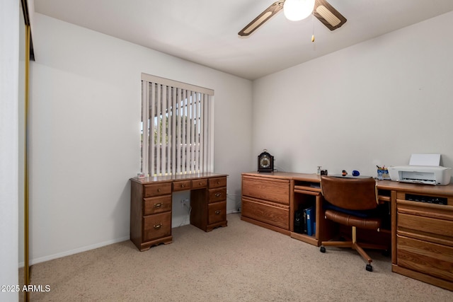 carpeted office space featuring ceiling fan