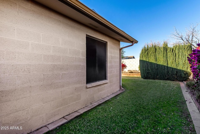 view of property exterior with a yard