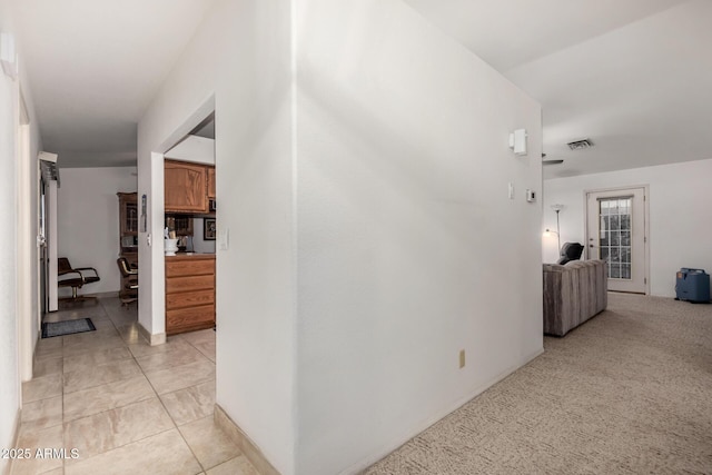 hallway with light tile patterned floors