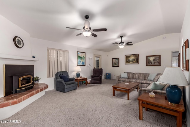 carpeted living room featuring vaulted ceiling, ceiling fan, and a wood stove