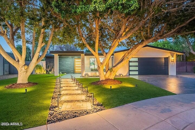 view of front of house with a garage and a front yard