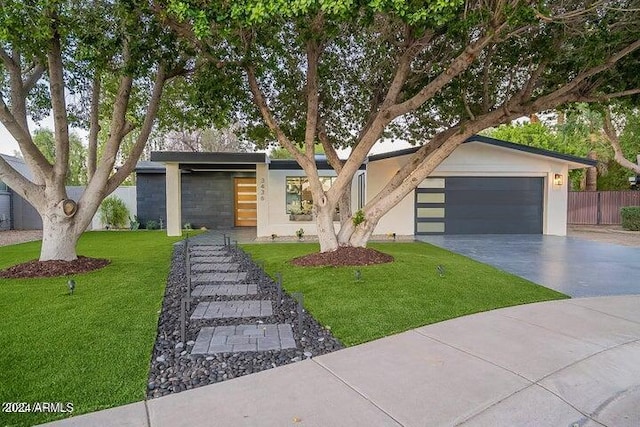 contemporary home featuring a front lawn and a garage