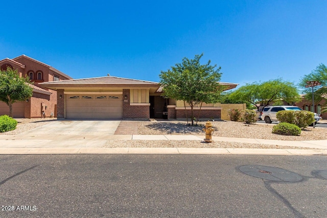11249 N 161st Ave, Surprise, AZ 85379 - view of front facade featuring an attached garage, driveway, and brick siding
