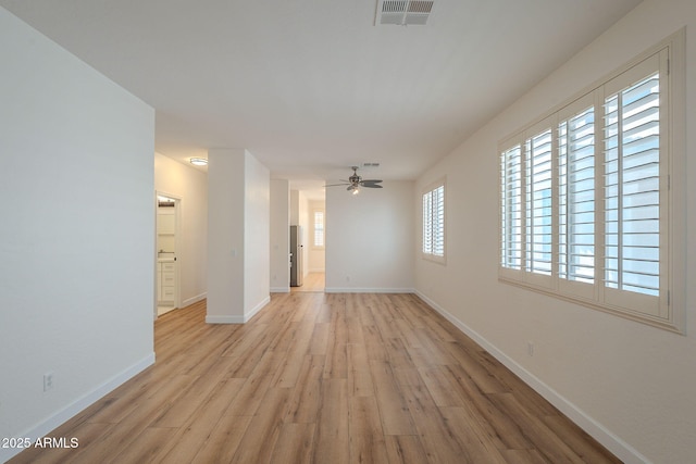 125 N 22nd Pl Unit 5, Mesa, AZ 85213 - empty room featuring light wood finished floors and ceiling fan