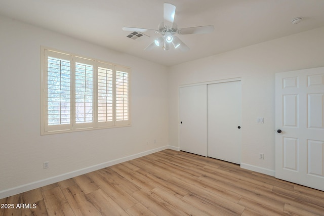 125 N 22nd Pl Unit 5, Mesa, AZ 85213 - unfurnished bedroom with light wood-style floors, a closet, and a ceiling fan