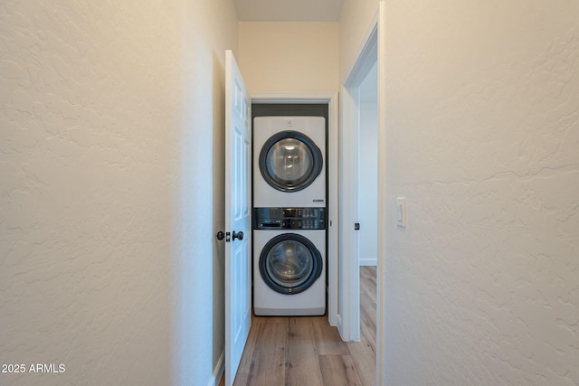 125 N 22nd Pl Unit 5, Mesa, AZ 85213 - washroom featuring stacked washing machine and dryer, a textured wall, and light wood finished floors