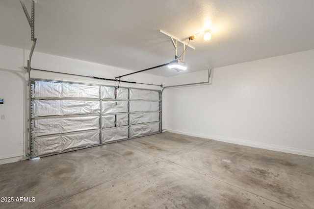 125 N 22nd Pl Unit 5, Mesa, AZ 85213 - garage with a garage door opener and baseboards