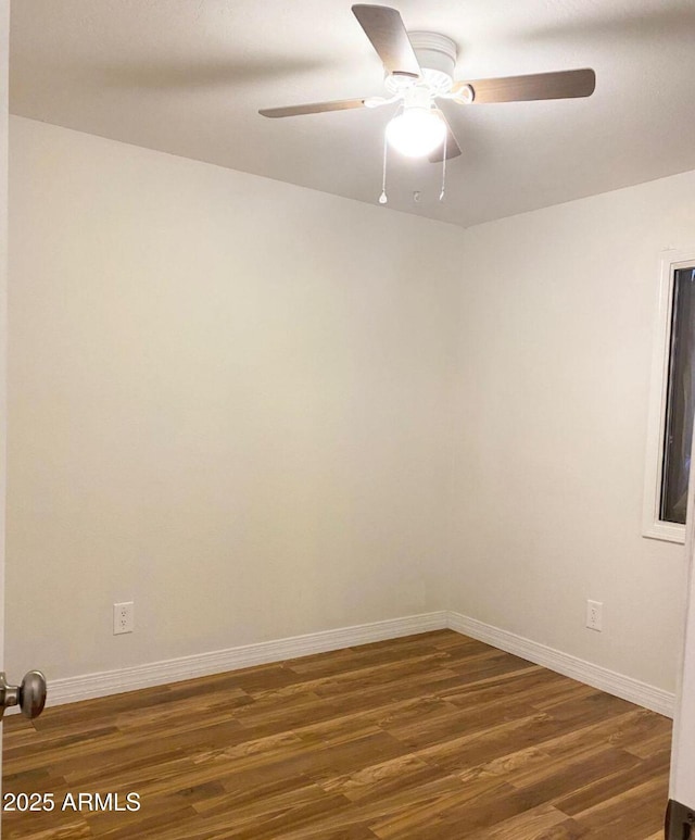 empty room with ceiling fan and dark hardwood / wood-style floors